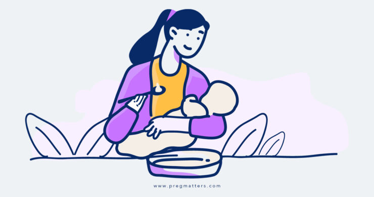 Mother Feeding Food To Baby